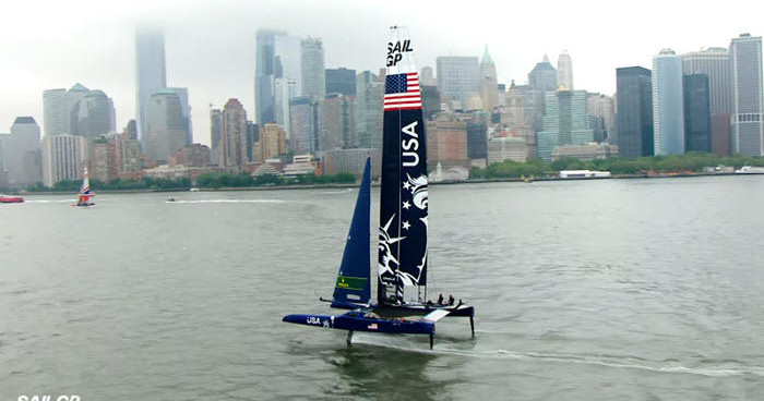 a small boat in a body of water with a city in the background