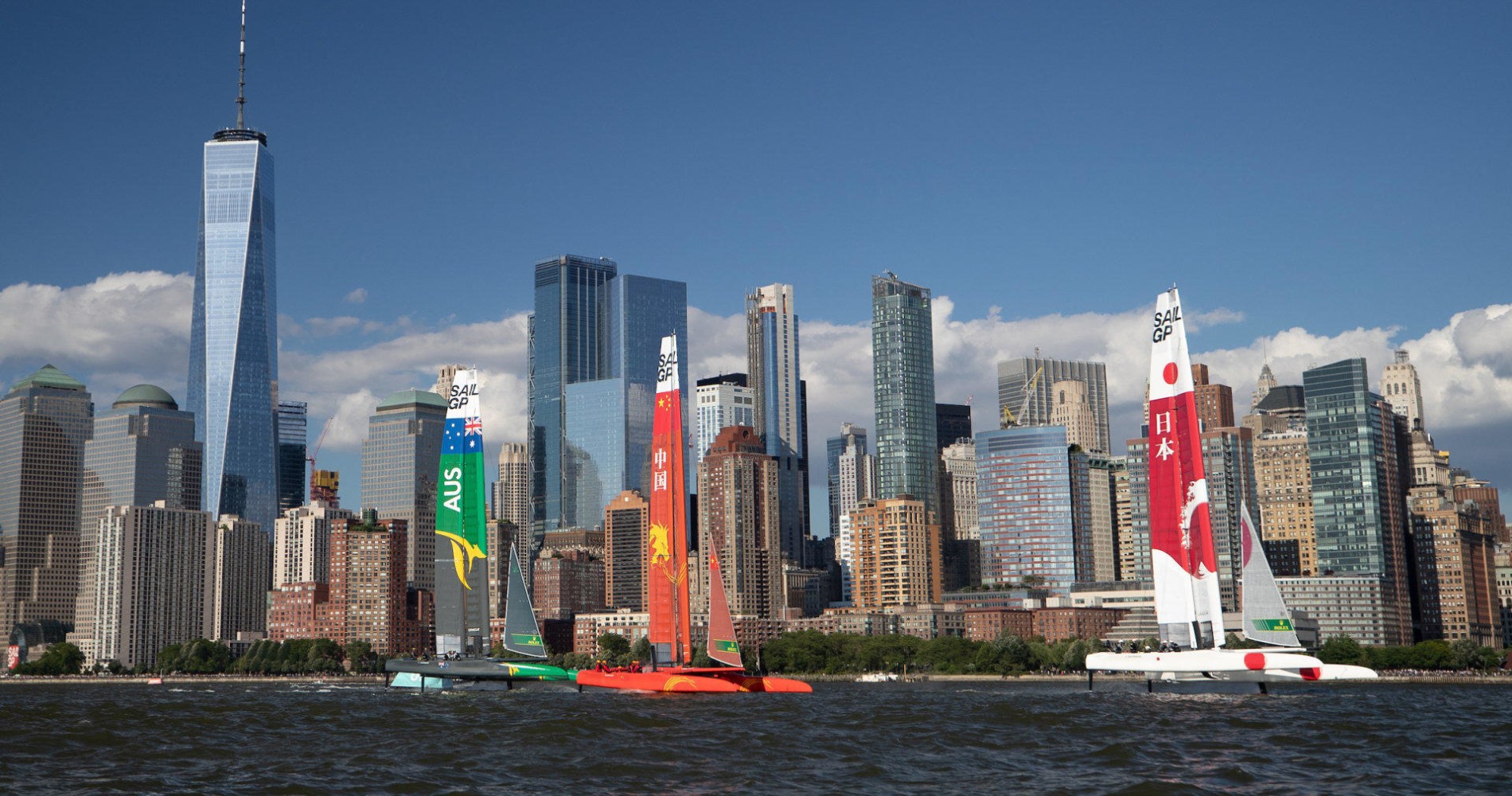 a large body of water with a city in the background