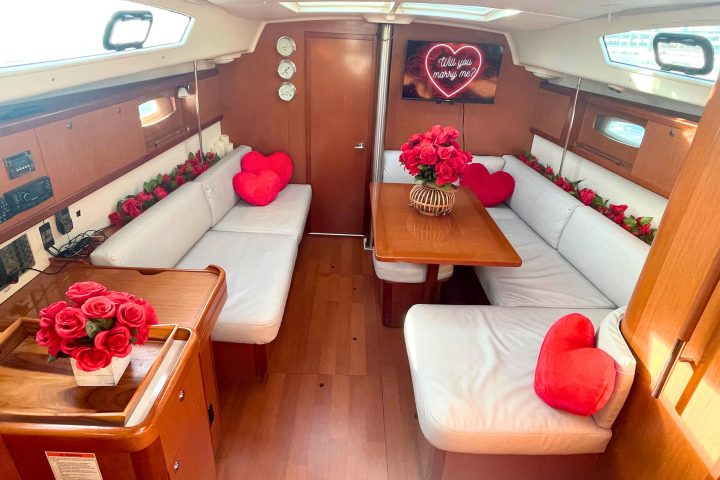 romantic boat ride in NYC with red roses decorating the interior cabin of a boat
