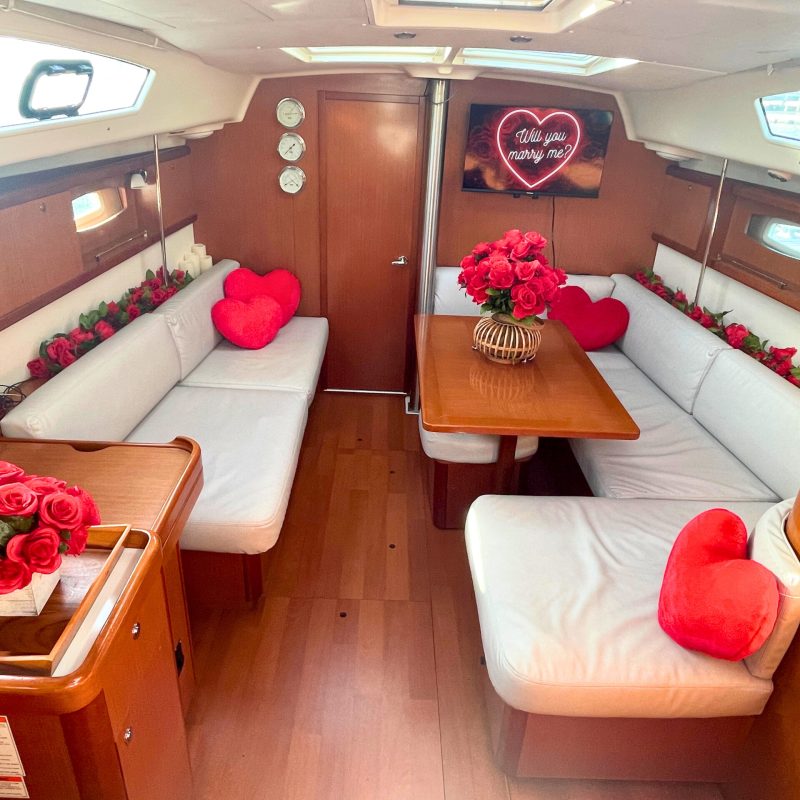 romantic boat ride in NYC with red roses decorating the interior cabin of a boat