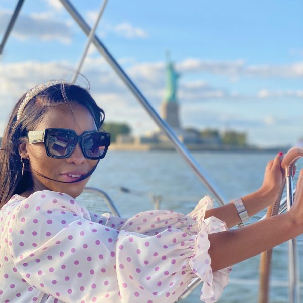 woman behind the helm on a sailboat ride in NYC