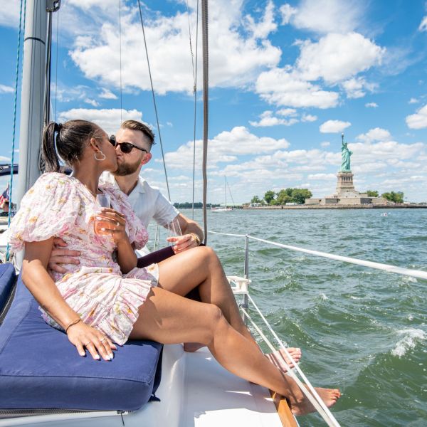 couple kissing during a marriage proposal on a yacht