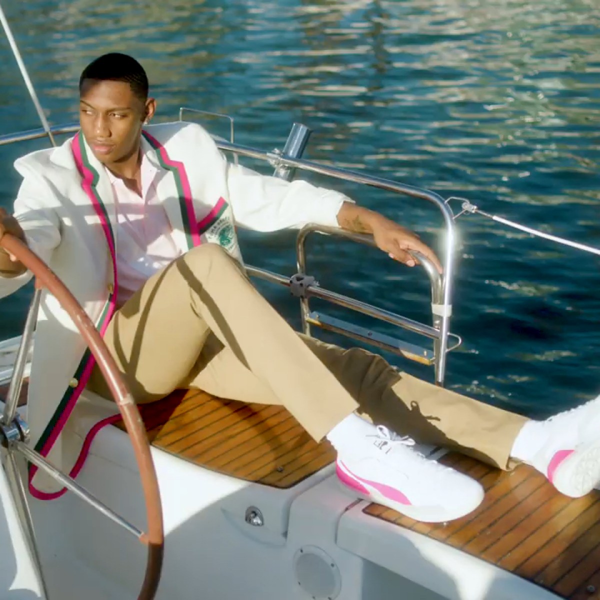RJ Barrett holding the steering wheel on a private sailboat in NYC