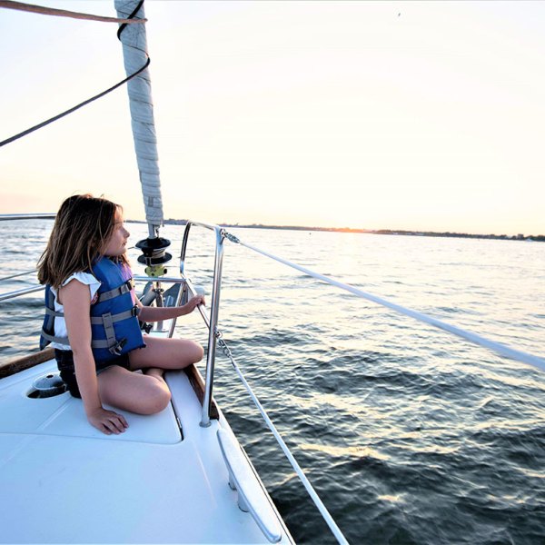 girl wearing a life vest while sailing New York
