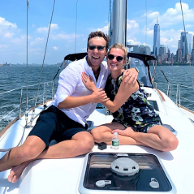 man and woman hugging on the deck of sailboat after proposal in NYC