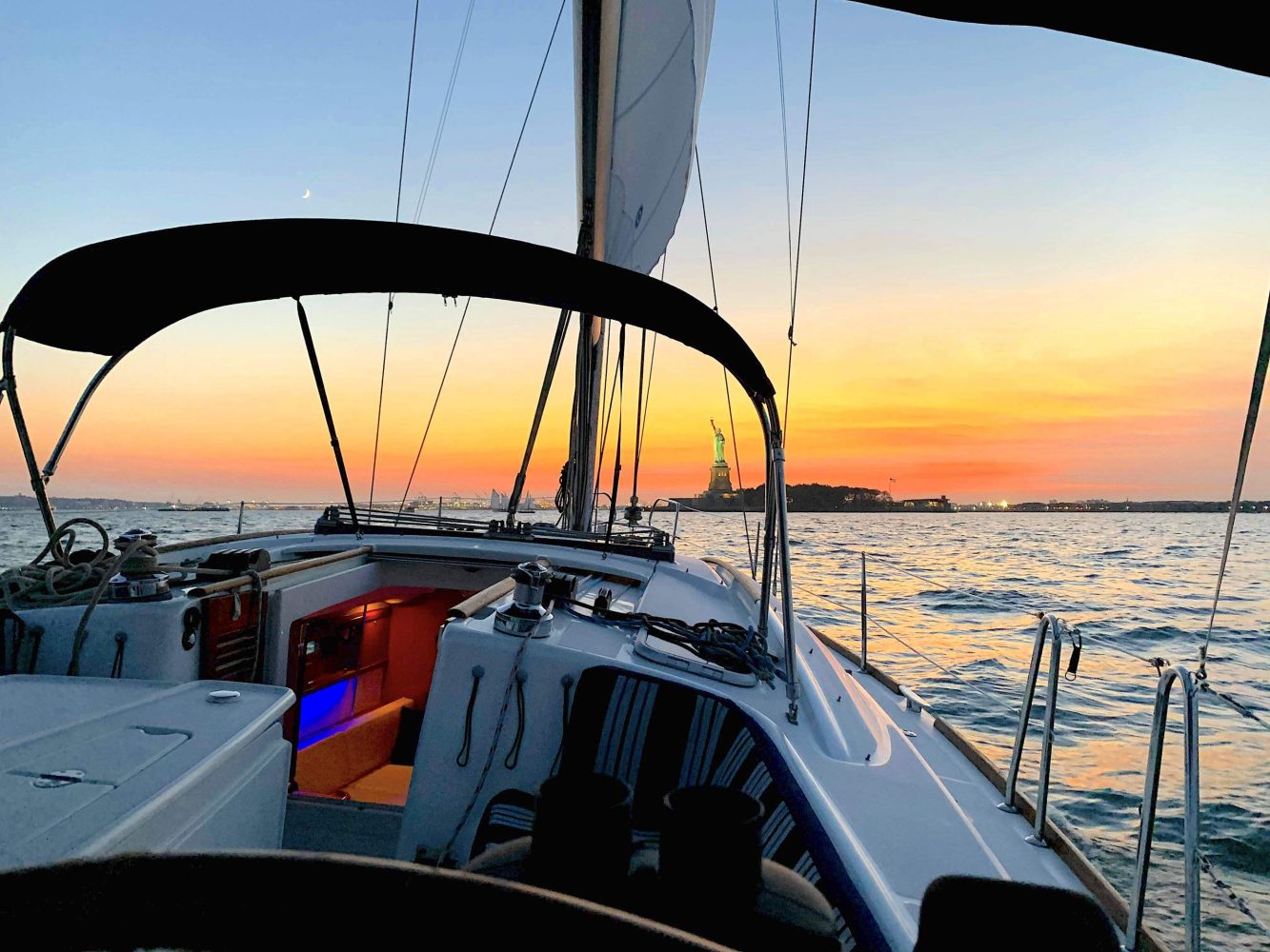 a close up of a sunset sail in Manhattan on the way to the Statue of Liberty