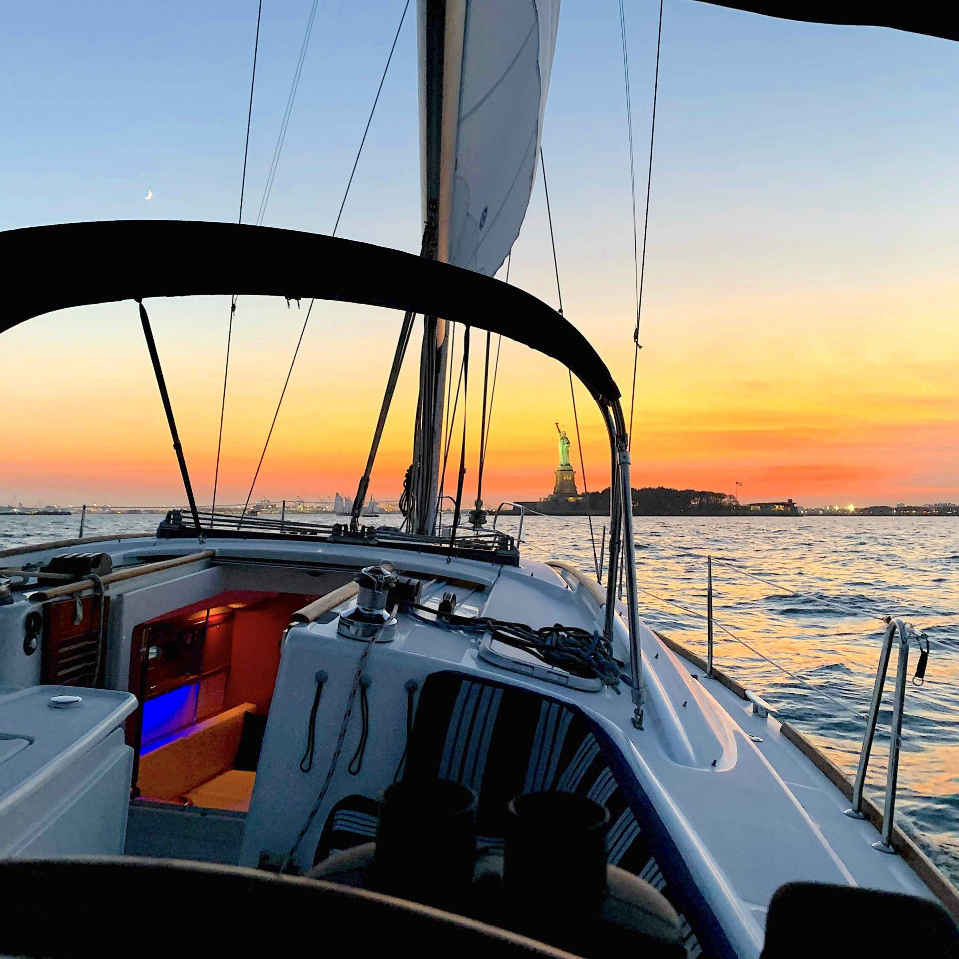a close up of a sunset sail in Manhattan on the way to the Statue of Liberty