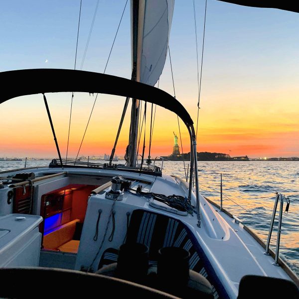 a close up of a sunset sail in Manhattan on the way to the Statue of Liberty