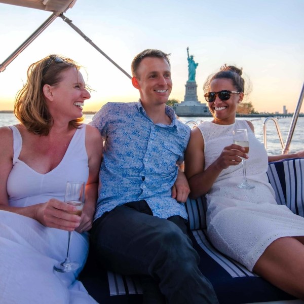 three friends drinking champagne during a private boat tour in New York