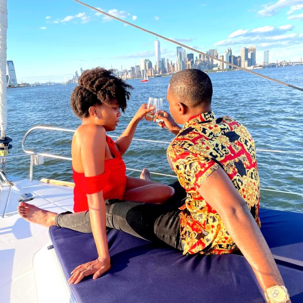couple toasting with champagne during a romantic boat ride in NYC