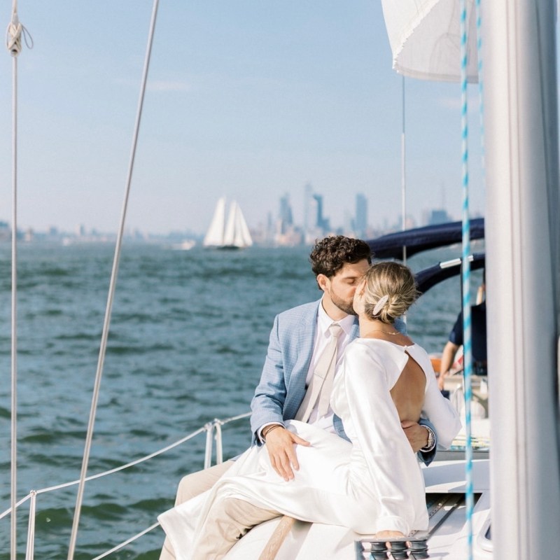 couple kissing during a boat engagement in NYC