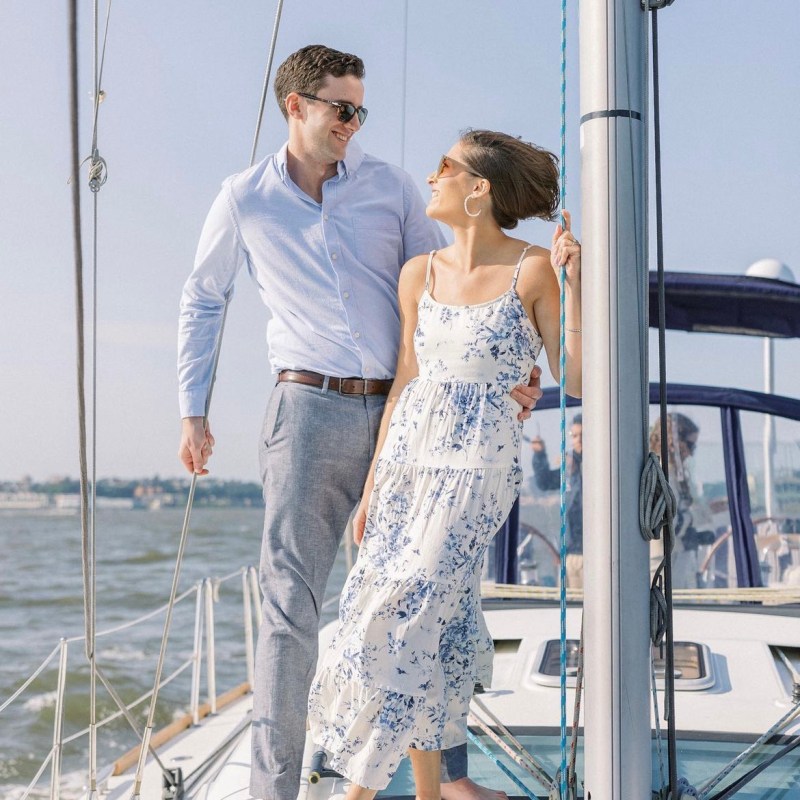 a man and woman standing on a boat private