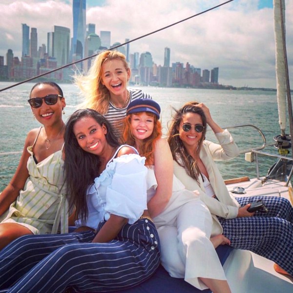 friends smiling and laughing during a sail tour of NYC
