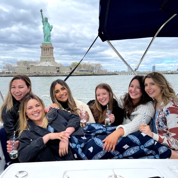 friends by the Statue of Liberty on a NYC private boat tour