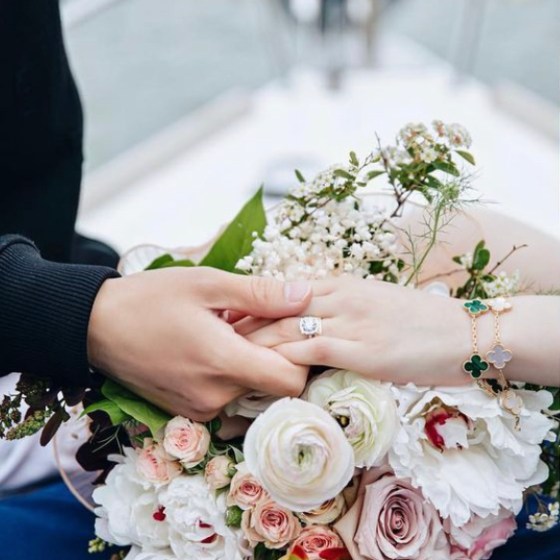 romantic boat with flowers and engagement ring during a sailboat proposal