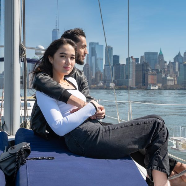 couple sitting on a blue cushion during a Hudson River boat charter
