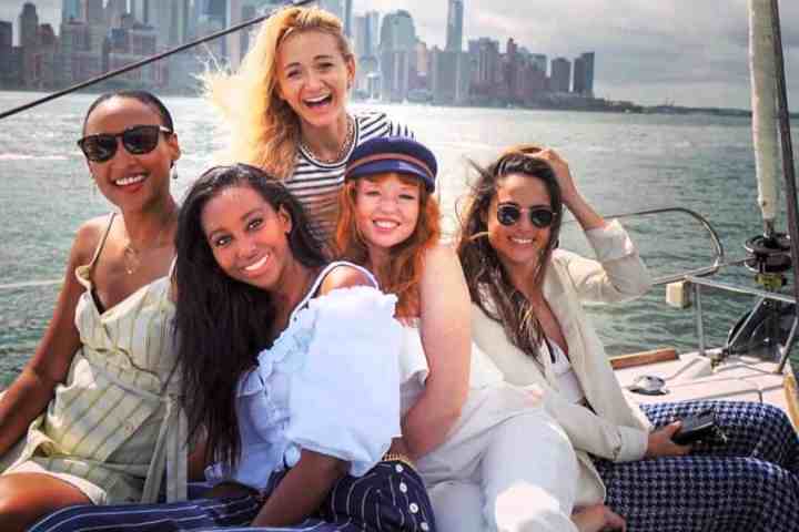friends on a sailboat cruise NYC in the middle of the harbor
