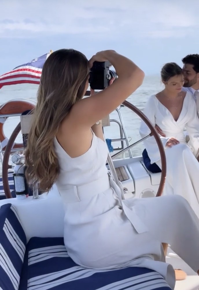 photographer taking photos of a couple during a yacht engagement shoot in NYC