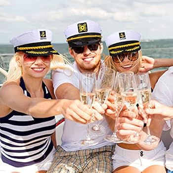 3 friends rent yacht in NYC for a birthday wearing captain hats and raising champagne glasses