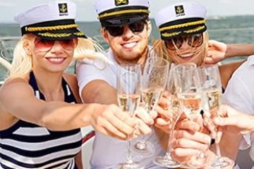 3 friends rent yacht in NYC for a birthday wearing captain hats and raising champagne glasses