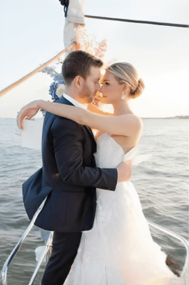 man and woman in a white dress looking romantically into each other's eyes making boat rides NYC romantic