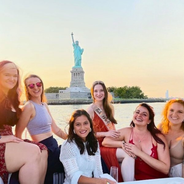 6 friends on a Statue of Liberty Sailboat Tour with Lady Liberty in the background