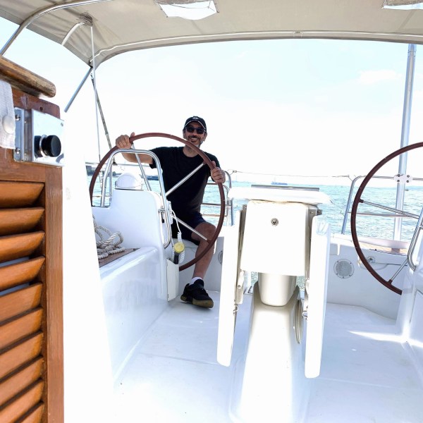 captain at the helm of a rental boat NYC