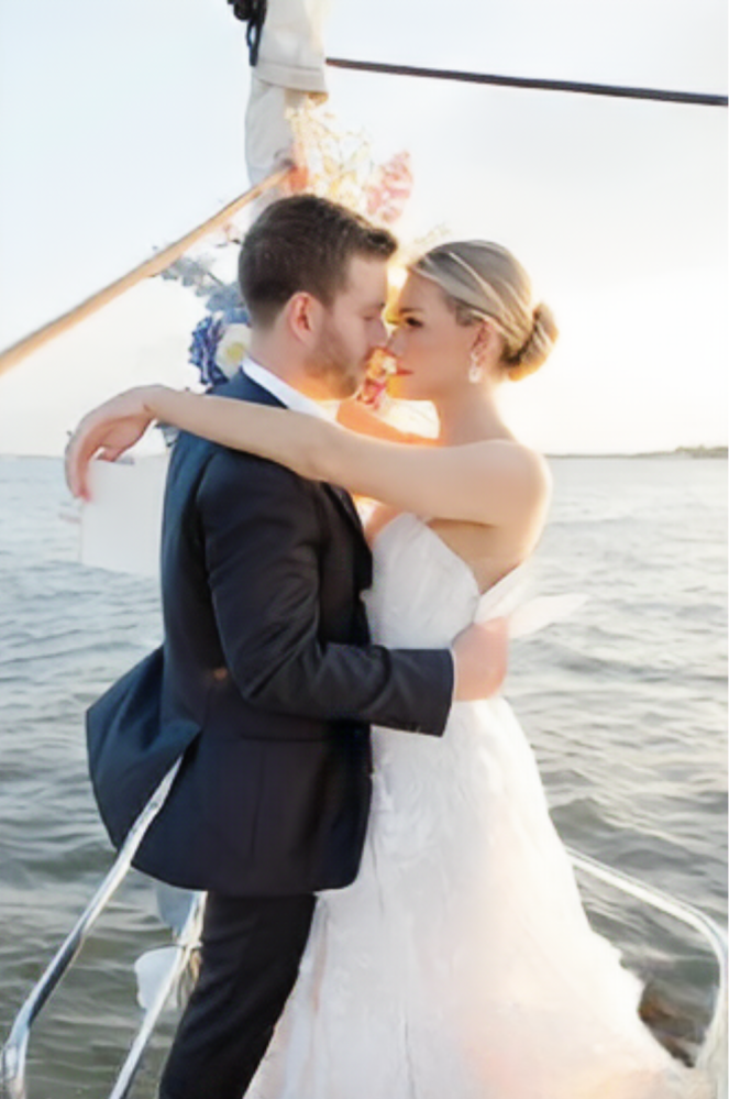 man and woman in a white dress looking romantically into each other's eyes, and that makes boat rides NYC romantic