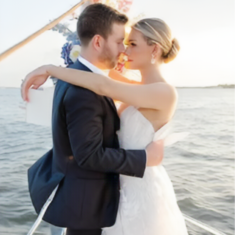 man and woman in a white dress looking romantically into each other's eyes, and that makes boat rides NYC romantic