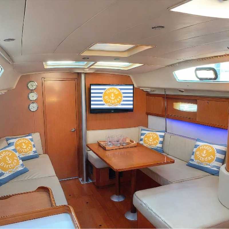 Interior of a yacht with nautical decor and 'Happy Birthday' pillows for a private party in NYC.