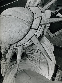 Aerial view of the Statue of Liberty's head and crown with spikes visible.